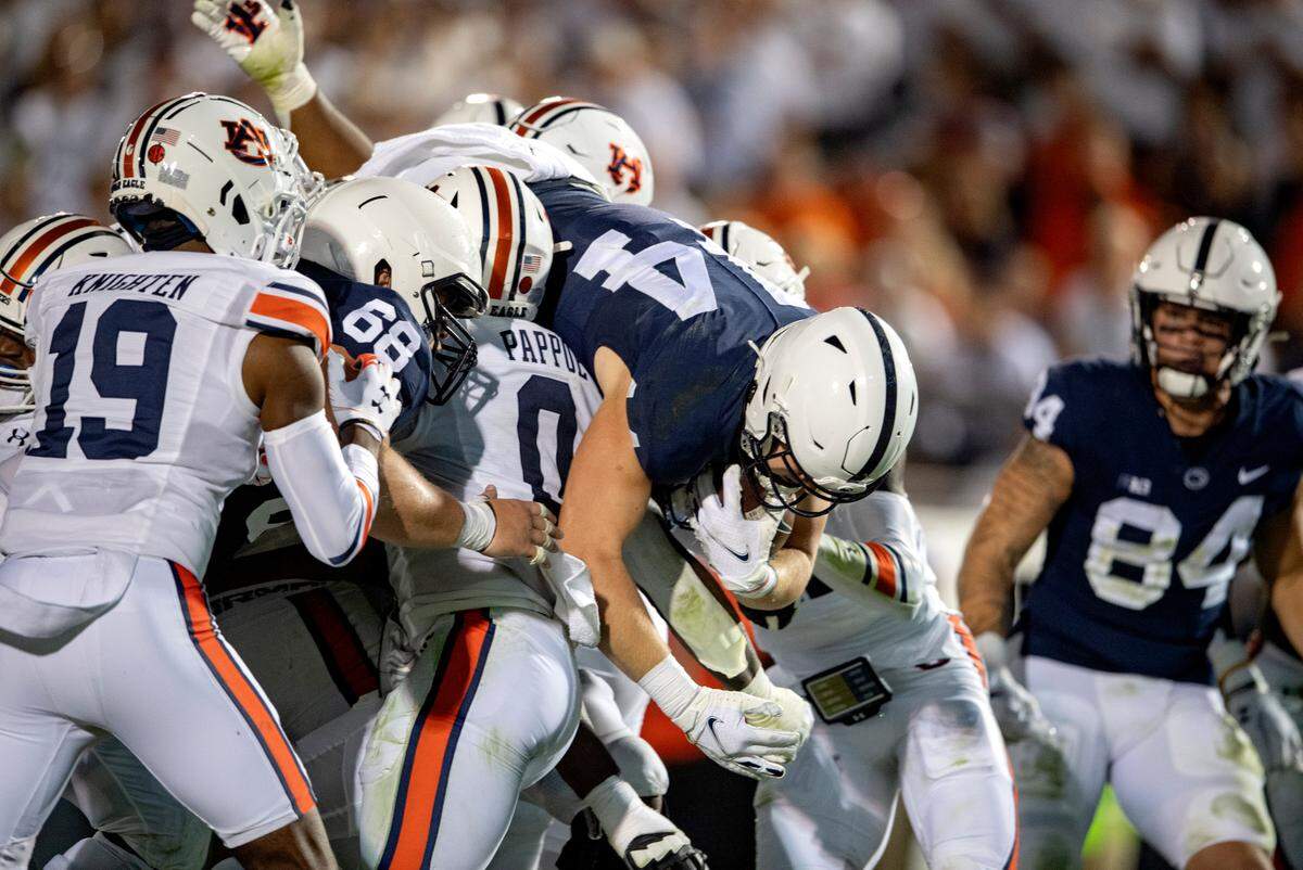Penn State tight end Tyler Warren leaps over Auburn’s defense for a touchdown during the game.