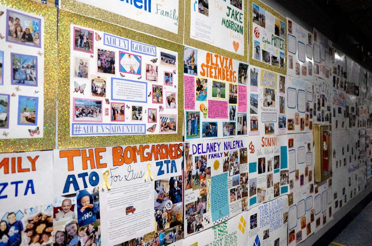A hallway at the Bryce Jordan Center is covered in posters supporting Four Diamond children during Penn State Thon on Friday, Feb. 21, 2025.