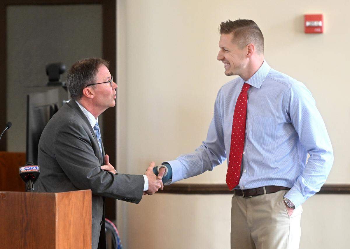 Chief John Petrick of the Ferguson Township Police Department congratulates Detective Caleb Clouse for being named one of the Law Enforcement Officers of the Year by the Centre County District Attorney’s Office on Thursday, July 13, 2023.