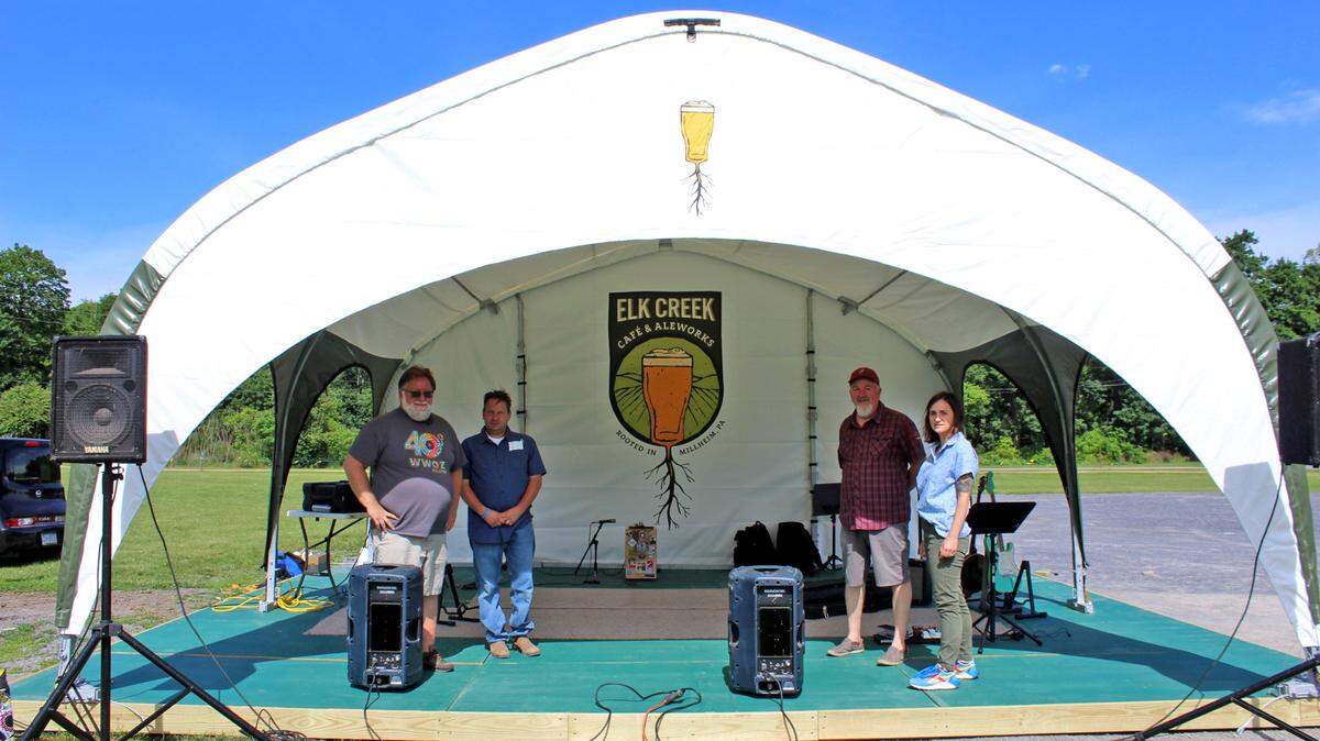 The Elk Creek Cafe recently purchased a high-tech stage that can withstand 70 mph winds for its outside live outdoor music events. From left, are Steve Crawford, of the Elk Creek Cafe’s house band, The Poe Valley Troubadors, Sean Hershey, of The Dilly Beans, Tim Bowser, Elk Creek Cafe proprietor, and Hannah Bingman, of The Dilly Beans.