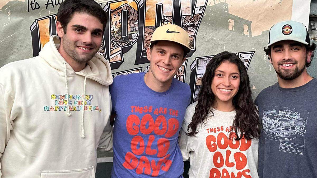 College Town Culture founders pose during a pop-up event at Doggies Pub in State College on Oct. 21. From left to right, Alex Baron, Mike Karns, Bella Granada and Bryce Eberly.