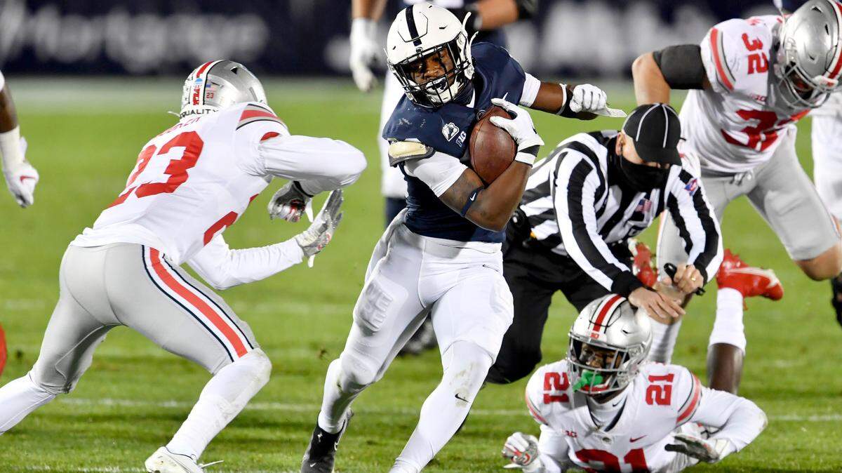Penn State running back Devyn Ford cuts down the field with the ball around a Ohio State defender during the game on Saturday, Oct. 31, 2020 at Beaver Stadium.