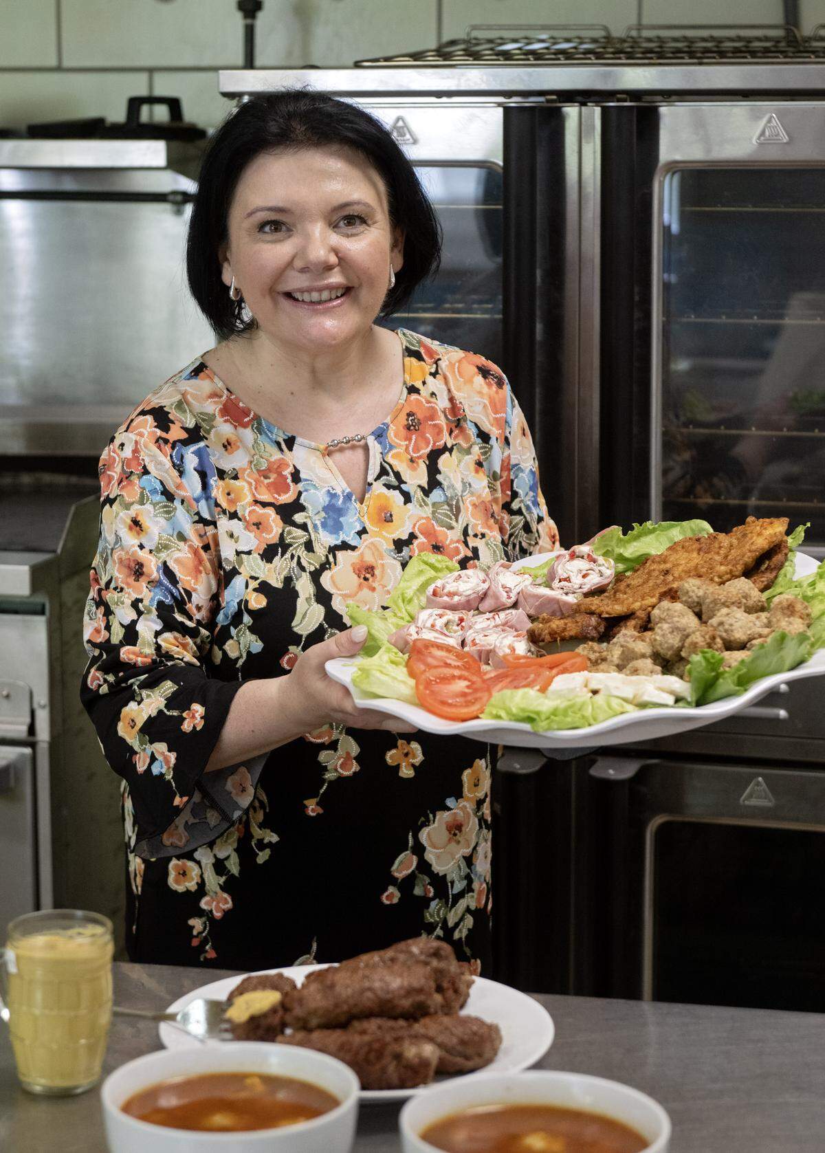 Carmen Miller of Taste of Transylvania holds an appetizer tray on Tuesday, May 19, 2026 in the kitchen at the Old Gregg School.  