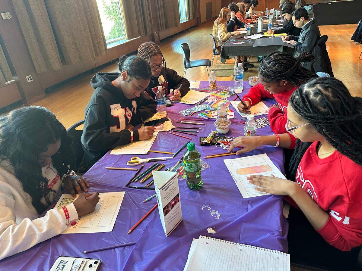 Penn State students, from left, Genesis Severino-Ellis, Kennedy Walker, Kayla Moore and Chenai Christian color bookmarks for the Maryland Book Bank during the Martin Luther King Jr. Day of Service on Monday, Jan. 16, 2023, in the HUB-Robeson Center’s Alumni Hall.