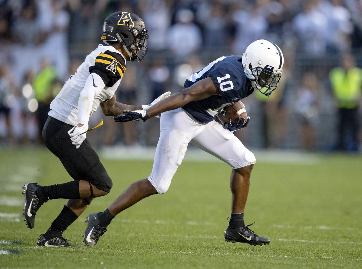 Penn State wide receiver Brandon Polk makes a catch and runs from an Appalachian State defender during the Saturday, Sept. 1, 2018 game at Beaver Stadium.