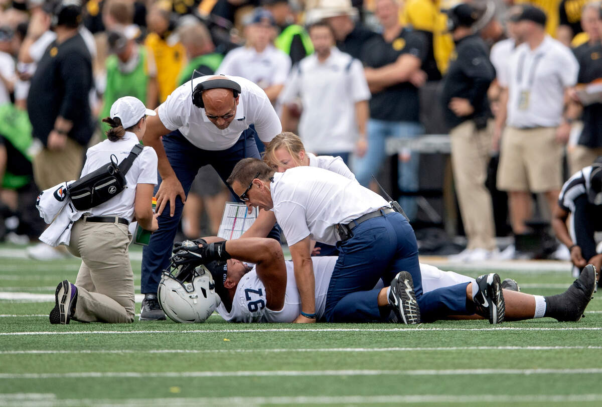 Trainers tend to Penn State defensive tackle PJ Mustipher after he went down on a play in the first quarter of the game against Iowa on Saturday, Oct. 9, 2021 at Kinnick Stadium.