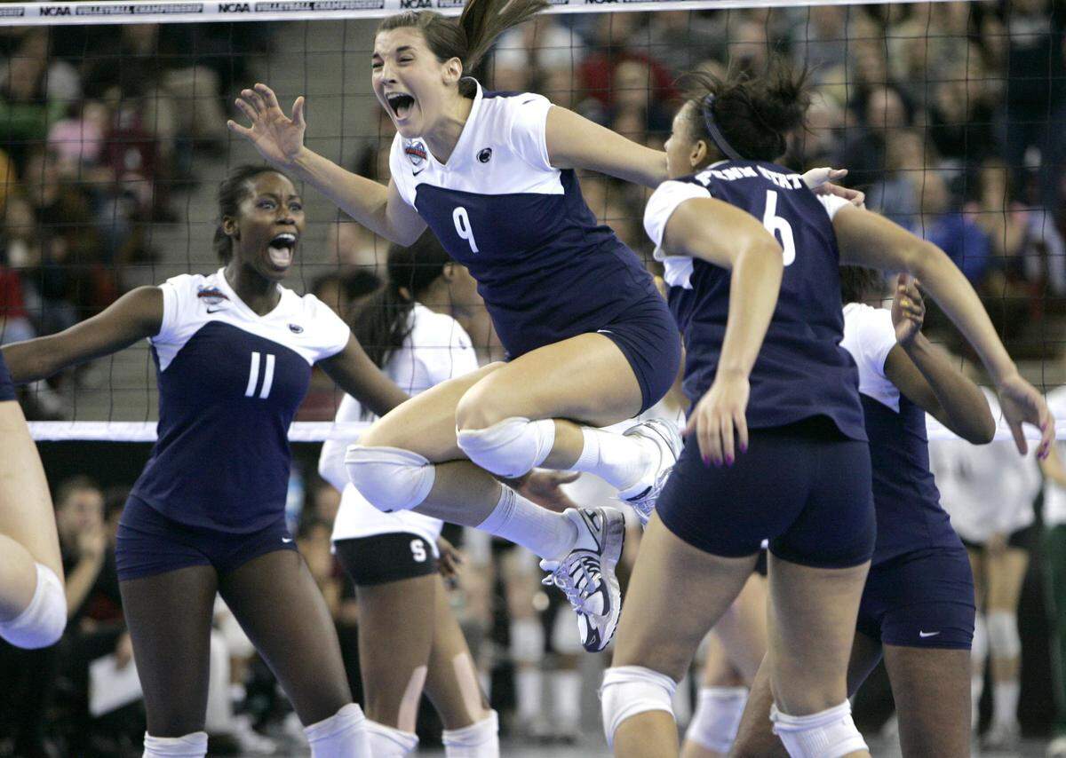Penn State’s Blair Brown, center, leaps in the air between teammates Megan Hodge, left, and Alisha Glass (6) after the winning point was scored to defeat Stanford 3-2 in the finals of the Women’s Division I NCAA volleyball championships in Sacramento, Calif., Saturday, Dec. 15, 2007. (AP Photo/Rich Pedroncelli)