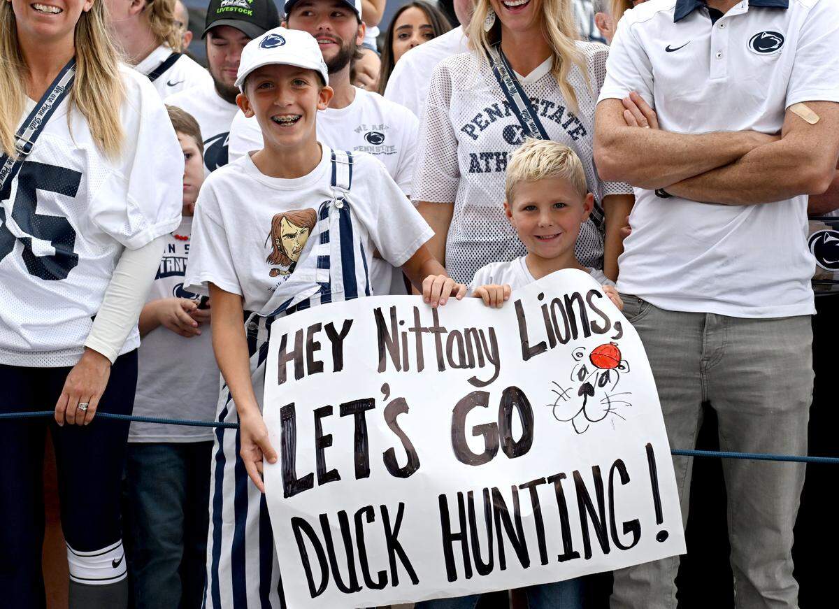 Young fans hold up a sign as they wait for the Penn State football team to arrive at Beaver Stadium for the game against Oregon on Saturday, Sept. 27, 2025.  
