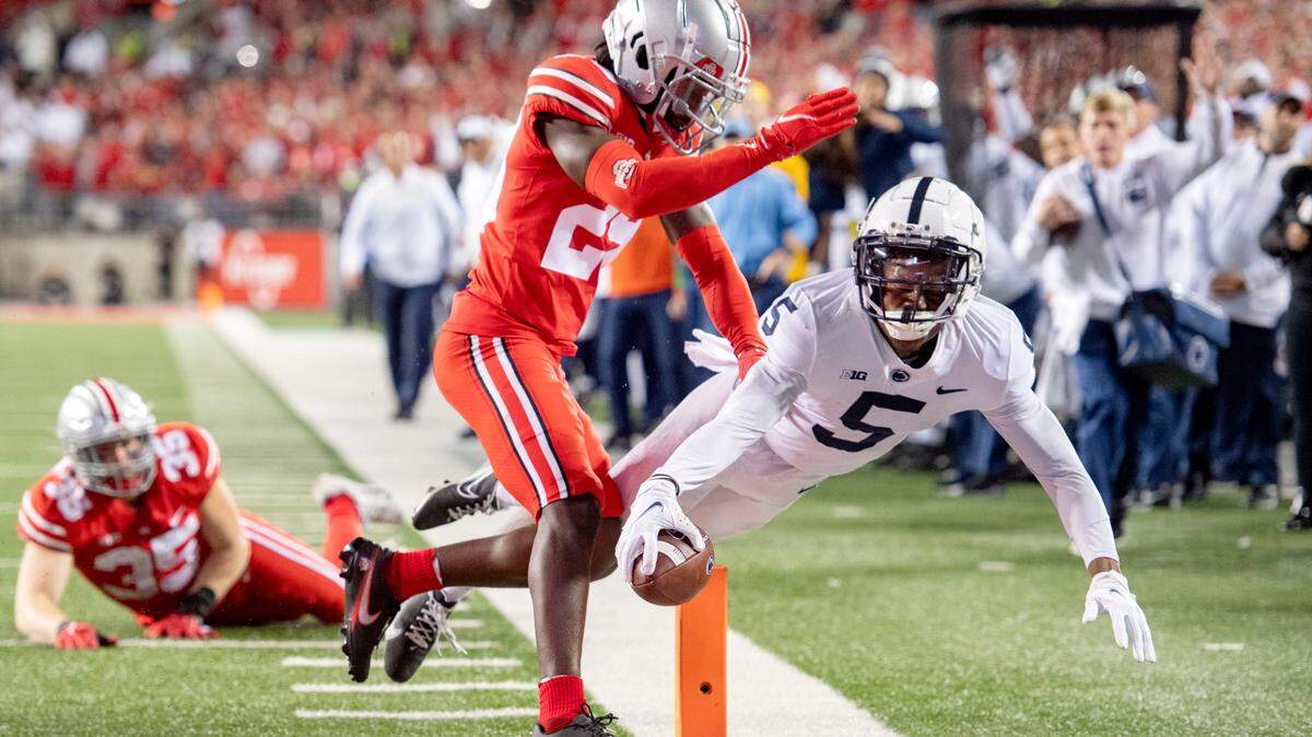 Ohio State defenders canÕt stop Penn State wide receiver Jahan Dotson as he dives into the end zone for a touchdown in the third quarter of the game on Saturday, Oct. 30, 2021 at Ohio Stadium.