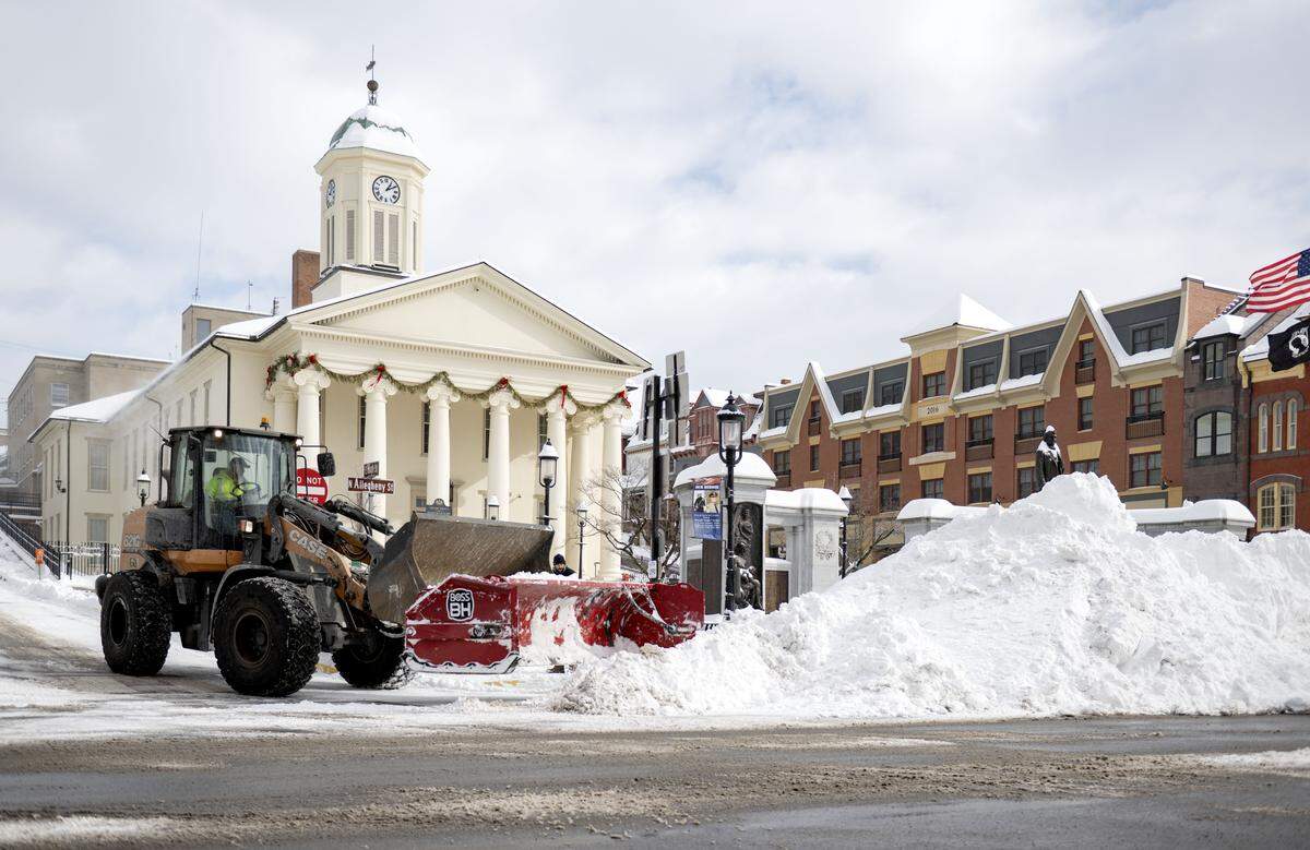 Snow is cleared from East High Street and piled along Allegheny Street in front of the Centre County Courthouse on Monday, Jan. 26, 2026.  