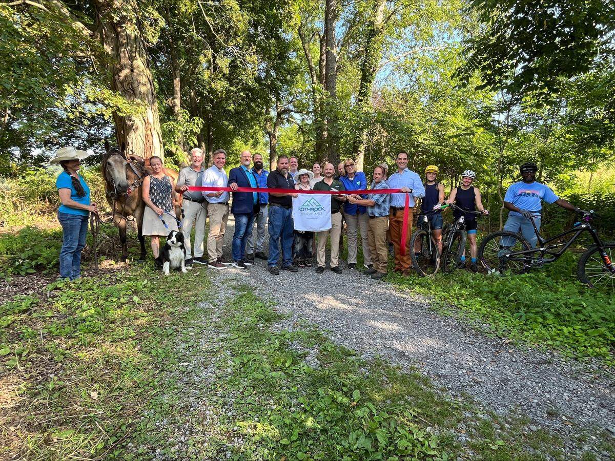 Trail volunteers and local officials cut a ribbon to officially open the first 7.5 mile stretch of the Musser Gap Trail in Rothrock State Forest on Thursday, July 10, 2025.