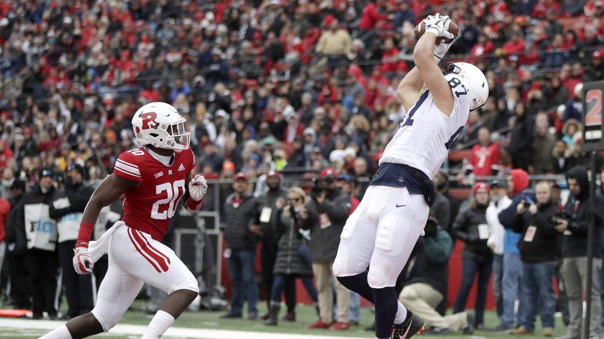 Penn State tight end Pat Freiermuth (87) catches a touchdown pass from quarterback Trace McSorley as Rutgers defensive back Avery Young (20) defends during the first half of an NCAA college football game, Saturday, Nov. 17, 2018, in Piscataway, N.J. (AP Photo/Julio Cortez)