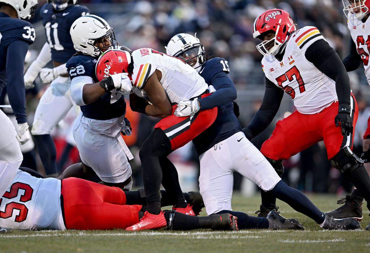 Penn State defensive tackle Zane Durant and defensive end Amin Vanover stop Maryland’s quarterback MJ Morris during the game on Saturday, Nov. 30, 2024.