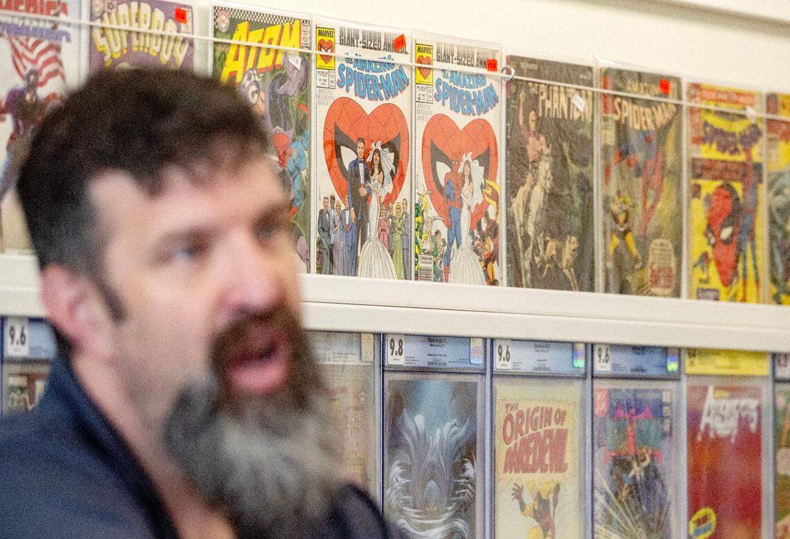 Justin Behrens talks about some of the books offered at his shop in the Westerly Plaza, Comic Cove, on Monday, May 20, 2024.