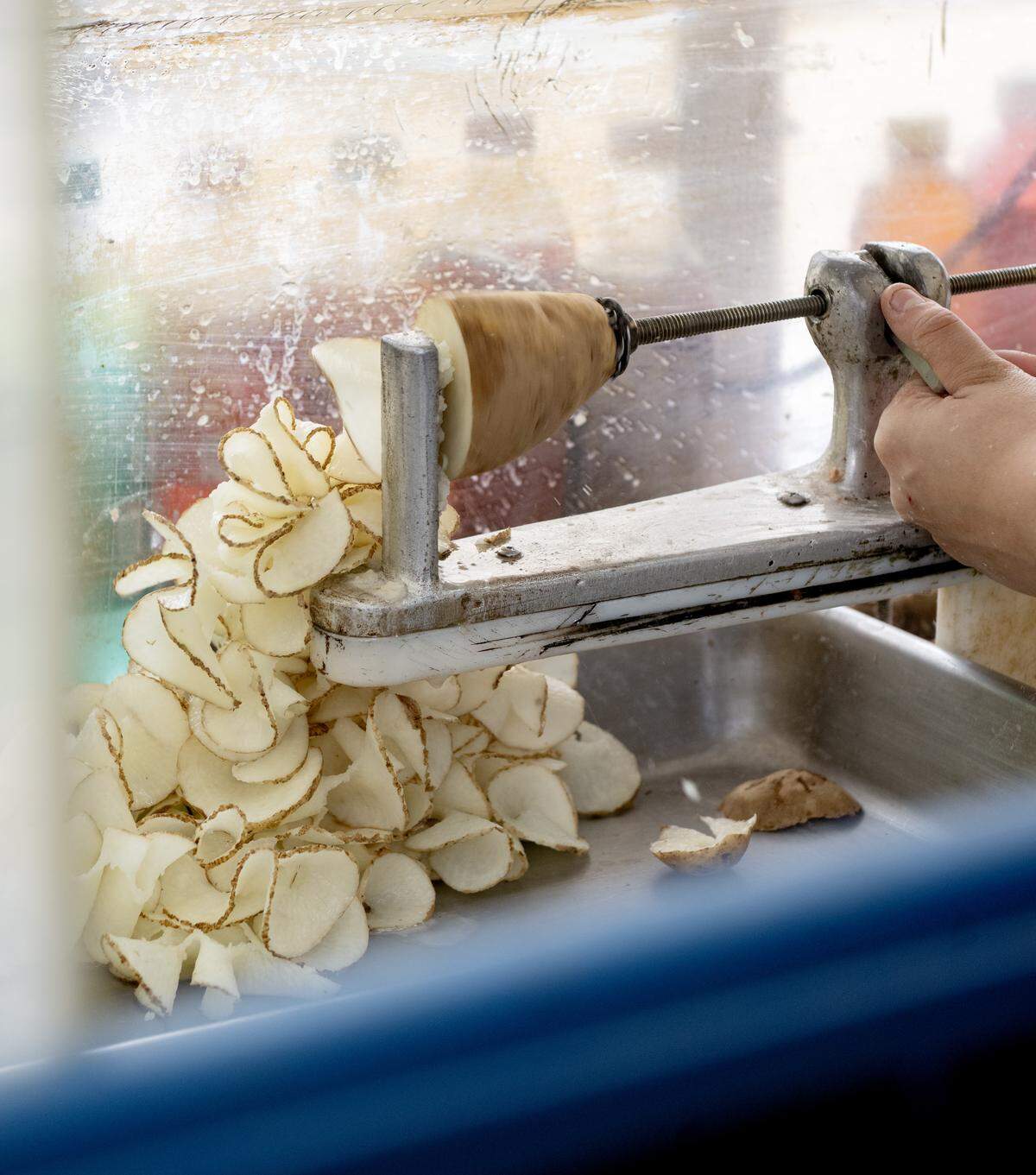 A potato is spiraled to be made into cactus taters at the Centre County Grange Fair on Friday, Aug. 15, 2025.