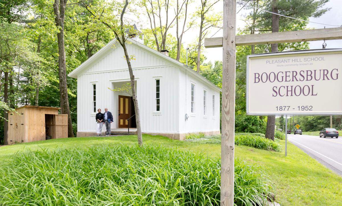 Centre County Historical Society executive director Mary Sorensen and president Roger Williams stand outside of the Boogersburg School on Thursday, May 29, 2025. The one-room schoolhouse along Fox Hill Road recently went through some restoration.