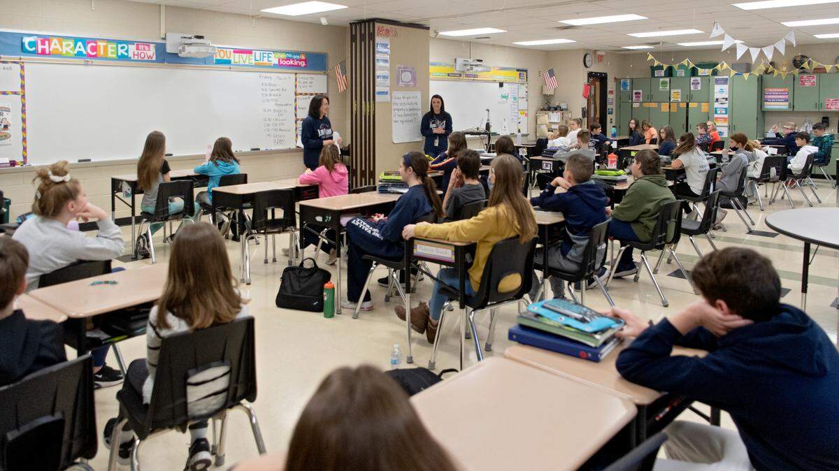 Karen McCaffrey and Michele Shawver teach math to their sixth grade class rooms at Penns Valley Intermediate school on Friday, March 4, 2022. There is a moveable wall that splits the classroom, but when one teacher was out sick and there were no substitute teachers available they opened the wall to combine the classrooms.