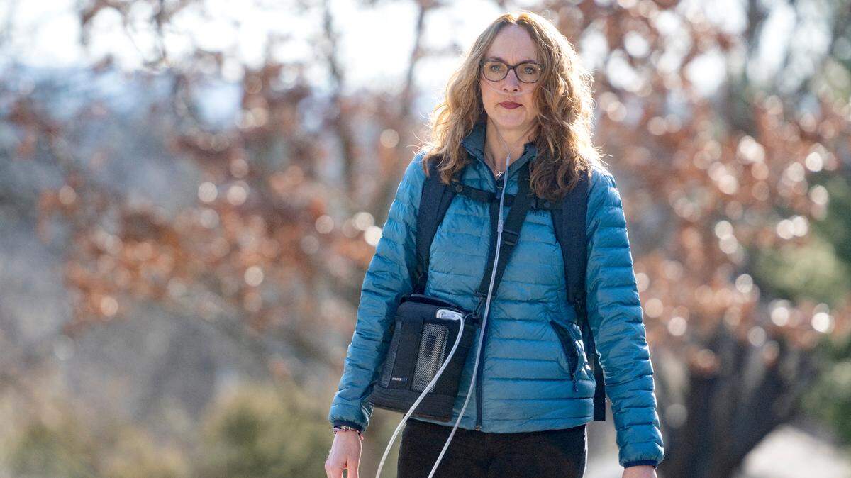 Esther Prins, a Penn State professor, has to use oxygen to walk to campus after health issues.