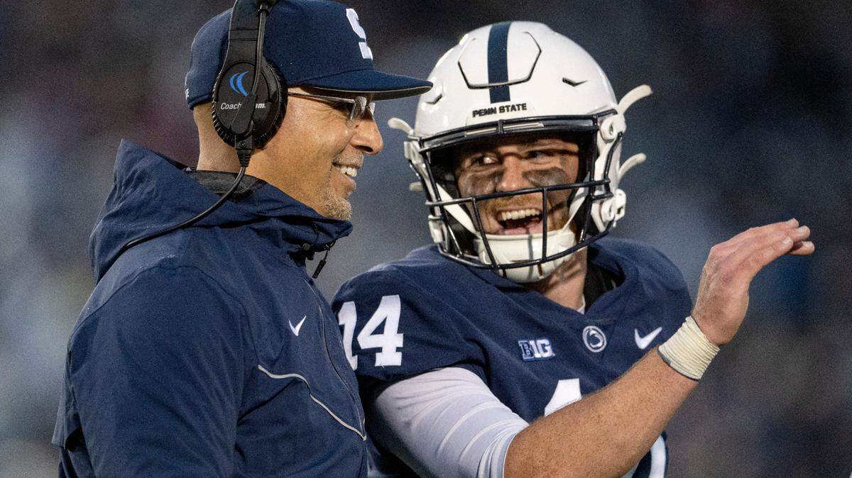 Penn State football coach James Franklin laughs with quaterback Sean Clifford after Nick Singleton scored a touchdown during the game against Maryland on Saturday, Nov. 12, 2022.