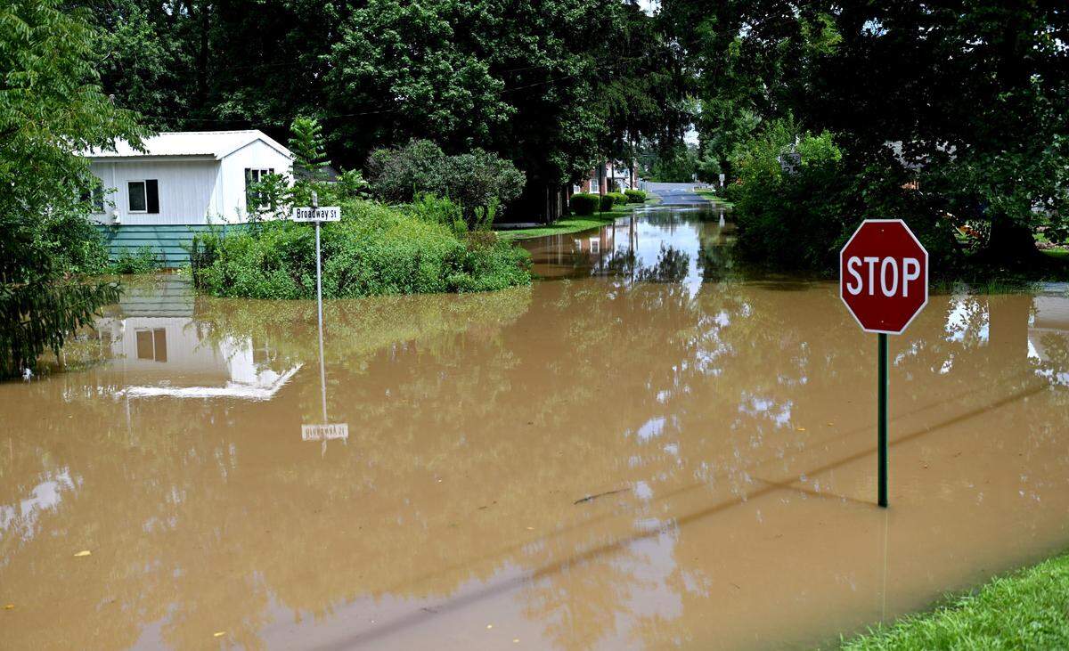 The intersection of Broadway Street and Iddings Street in Milesburg was flooded after heavy rains on Friday, August. 9, 2024.