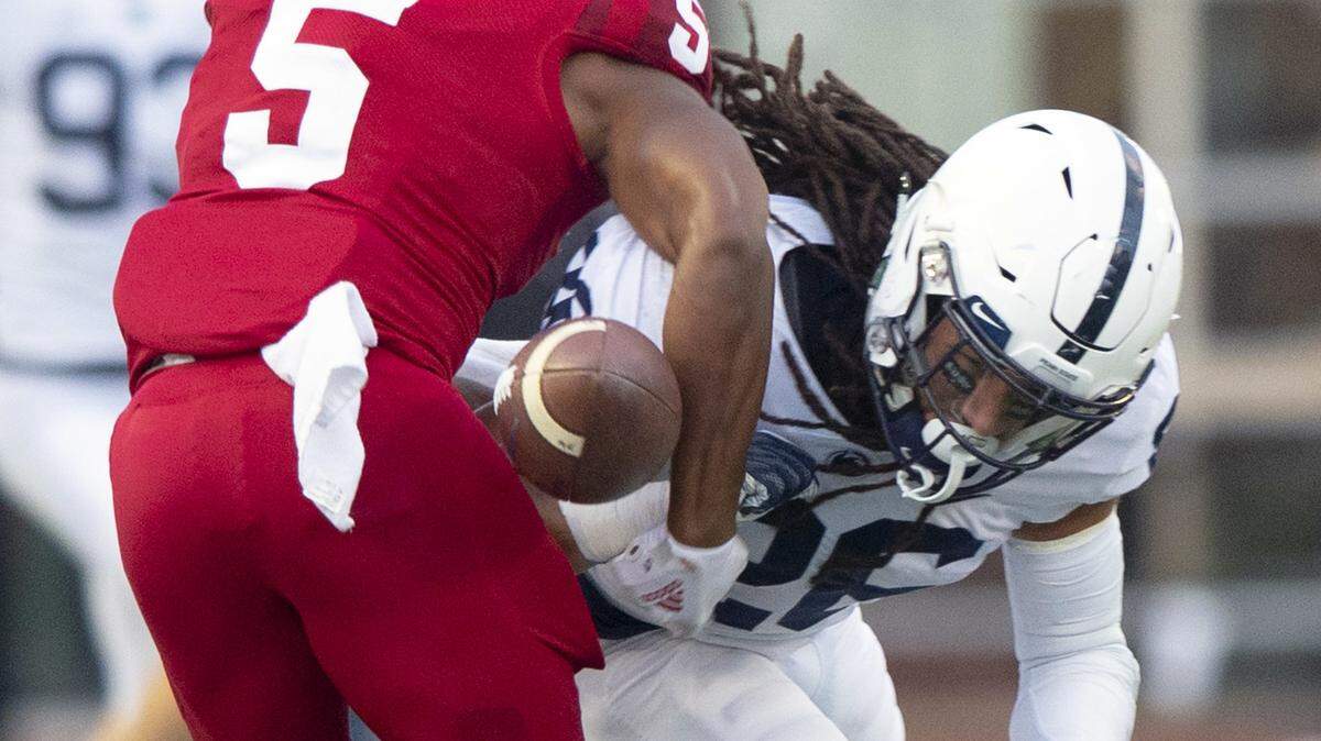 Penn State safety Jonathan Sutherland (26) knocks the ball away from Indiana wide receiver J-Shun Harris II (5) setting up a fumble recovery by Penn State during a punt return in the second half of Saturday game in Bloomington, Ind. Penn State won 33-28. (AP Photo/Doug McSchooler)