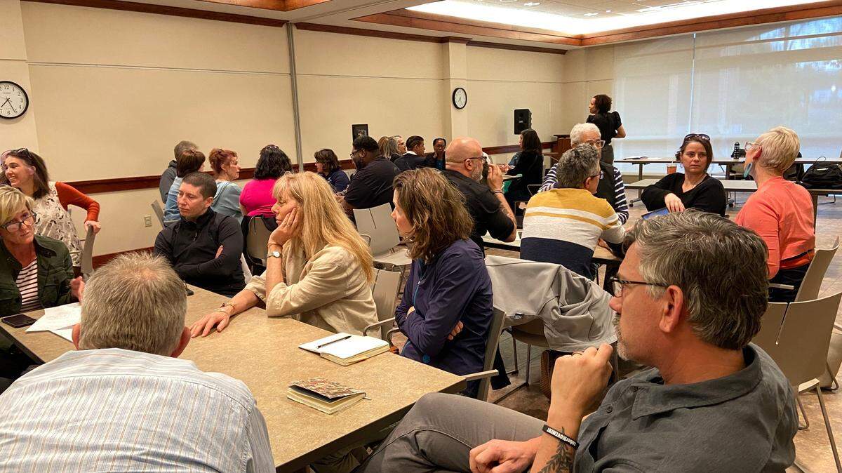 Parents, community members and district administrators speak in small groups at a State College Community Oversight Board meeting about police in schools at Schlow Centre Region Library on Thursday, April 28, 2023.