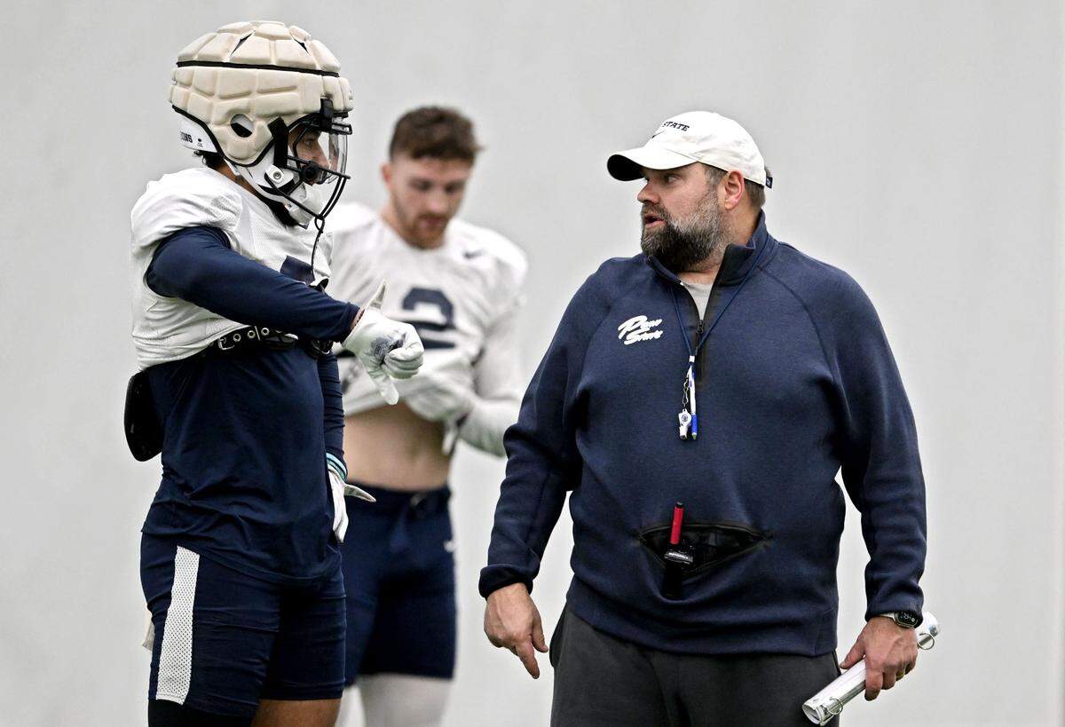 Penn State wide receiver Julian Fleming talks to offensive coordinator Andy Kotelnicki during practice on Wednesday, Dec. 4, 2024.