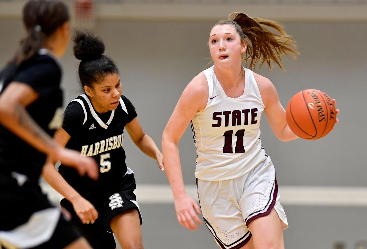 State College’s Maya Bokunewicz dribbles down the court around Harrisburg defenders during the game on Friday, Jan. 24, 2020.