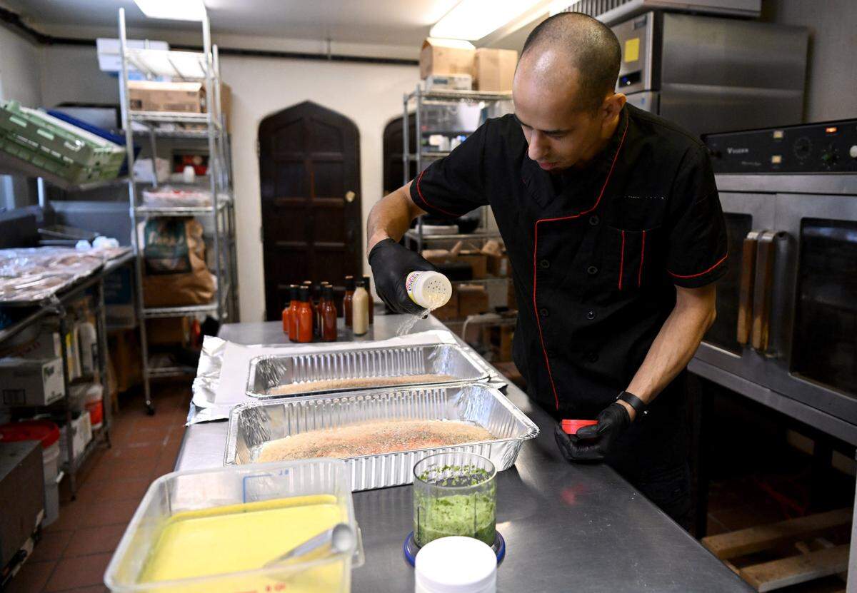 George Salgado prepares Spanish rice and beans for a Puerto Rican themed meal at Tau Kappa Epsilon fraternity on Tuesday, Jan. 16, 2024.