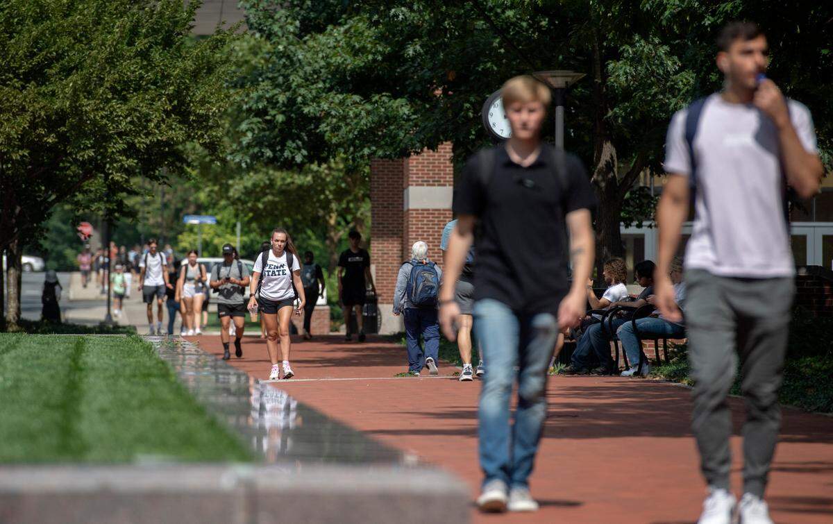 Penn State students walk on campus on the first day of classes on Monday, Aug. 23, 2021.