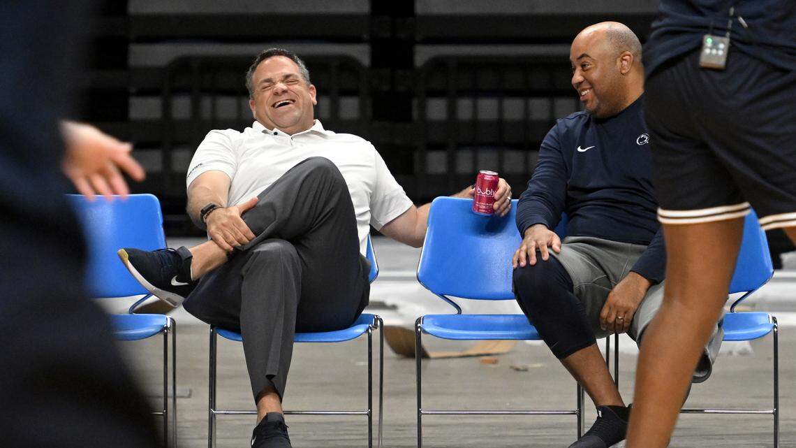 Penn State Athletic Director Pat Kraft, left, and Penn State men’s basketball coach Micah Shrewsberry talk as the hoops team warms up for a summer practice on July 19.