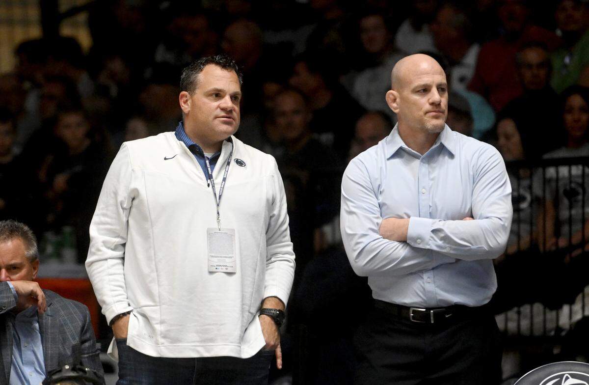 Penn State athletic director Pat Kraft talks with Penn State wrestling coach Cael Sanderson as a call if reviewed during the match against Lock Haven on Friday, Nov. 11, 2022.