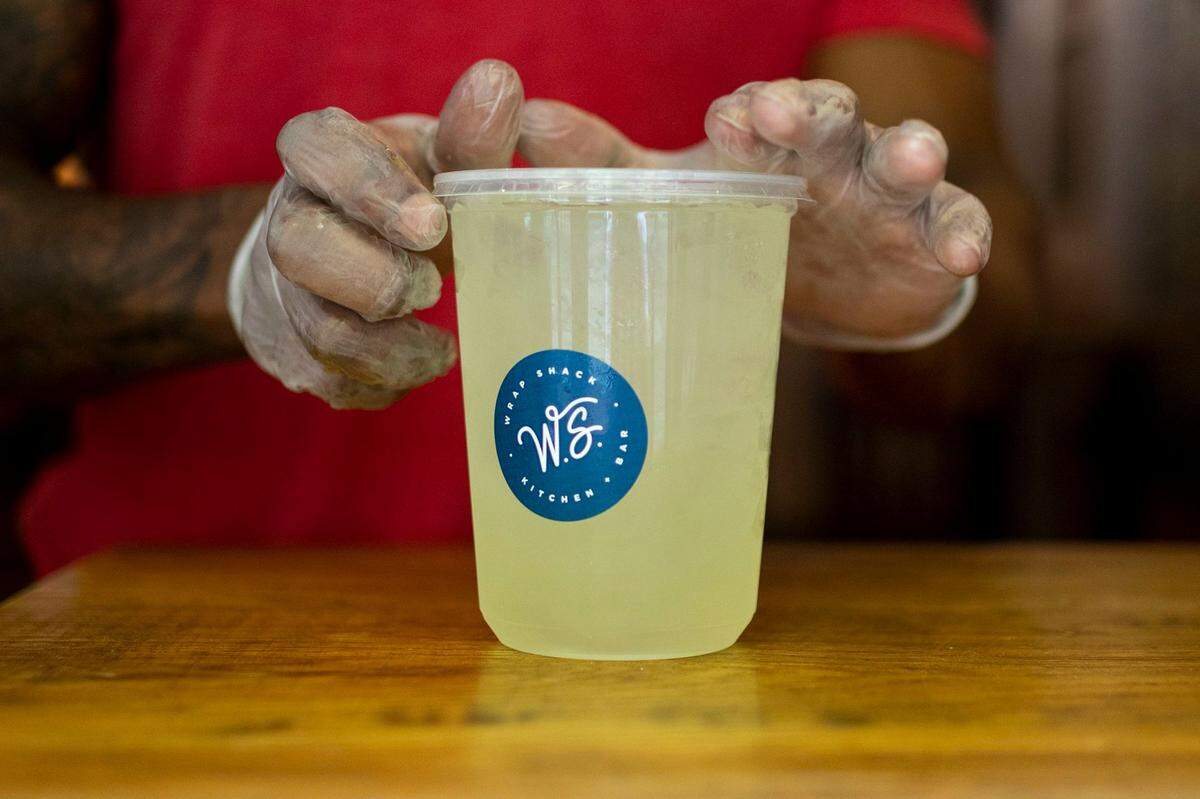 Kendrick Worth, manager at Wrap Shack in Philadelphia, creates a to-go margarita in May. Takeout cocktails are no longer allowed in the state.