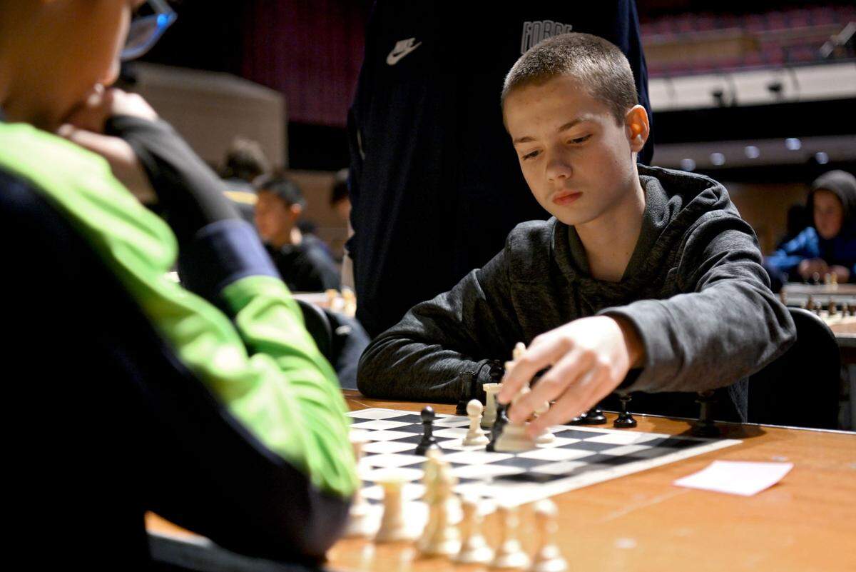 Eighth grader Weston Lenkey makes a move in his match against Ahaan Singh during the State College Area School District chess tournament on Tuesday, Feb. 20, 2024.