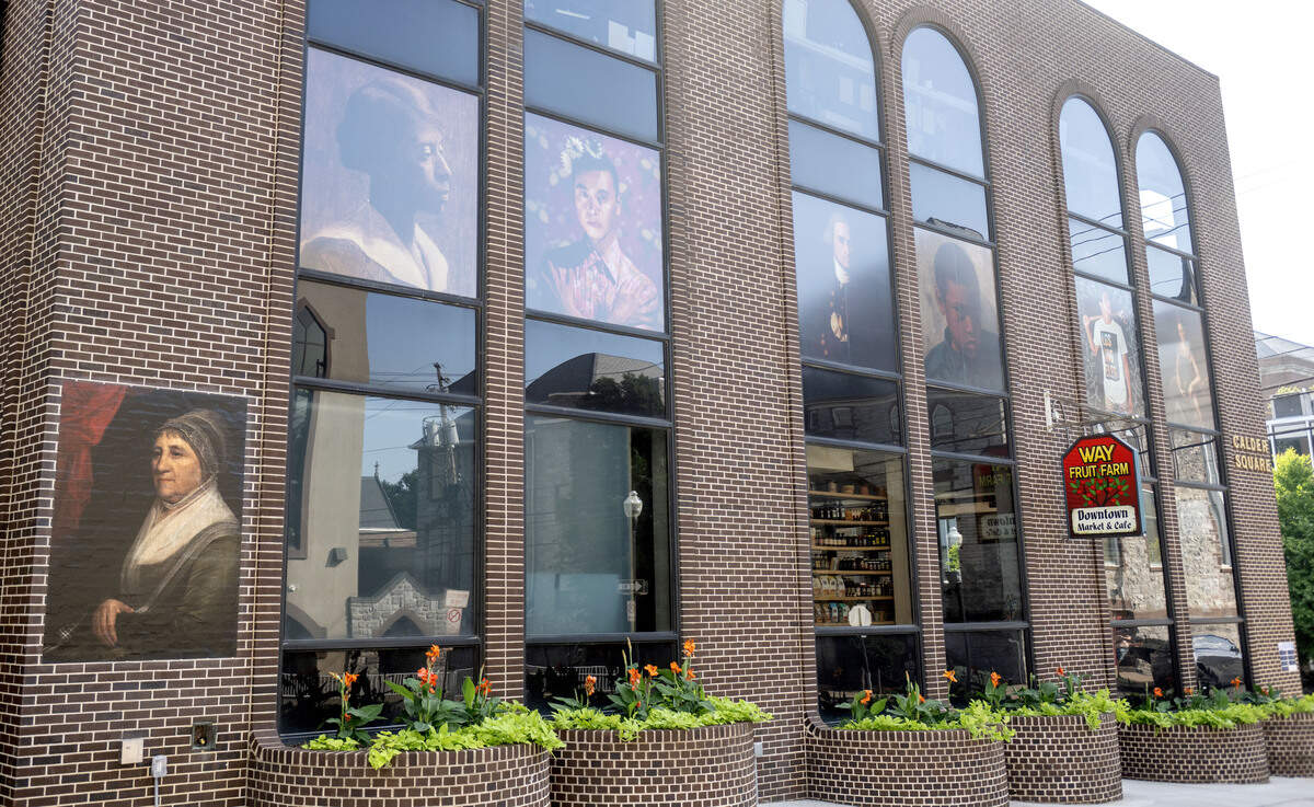 Large-scale replicas of several paintings are displayed on the side of 252 E. Calder Way as part of the “Looking at US: Celebrating America’s 250th” installation.