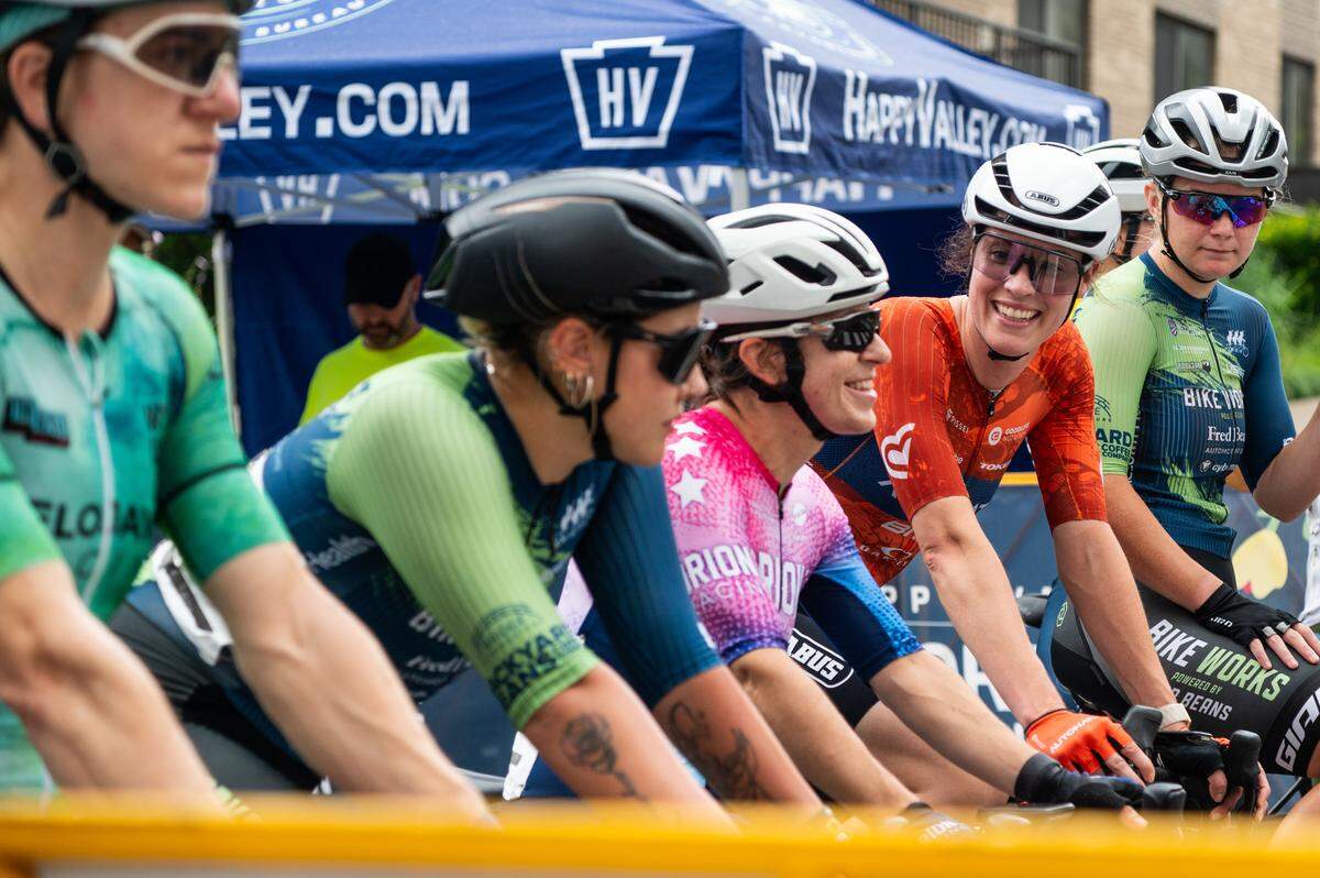 Participants of the Women’s Cat 1, Cat 2 and Cat 3 cycling race wait at the start line during the State College Criterium on Saturday, July 26, 2025 in State College, Pa.