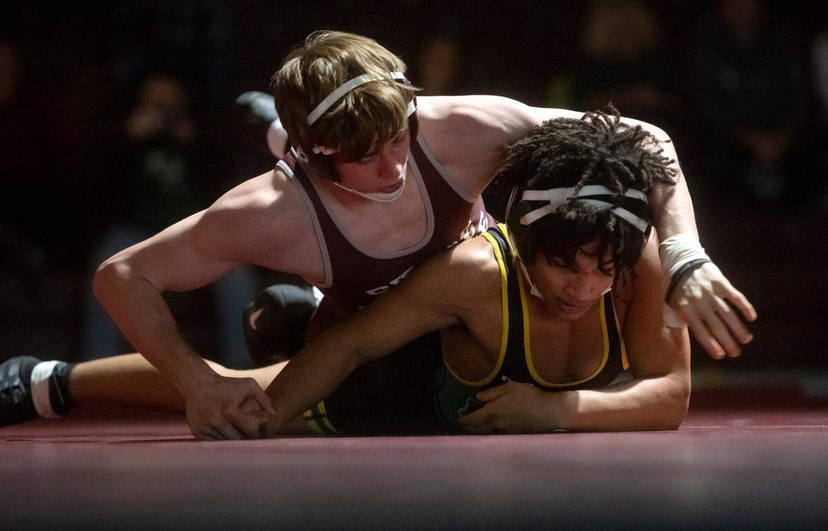 State College’s Hayden Cunningham controls Central Dauphin’s Dallas Schorr in the 133 lb bout of the match on Wednesday, Dec. 14, 2022. Cunningham won by major decision, 11-0.