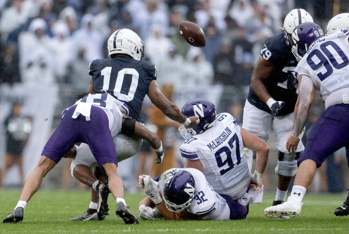 Northwestern defenders cause Penn State running back Nick Singleton to fumble during the game on Saturday, Oct. 1, 2022.
