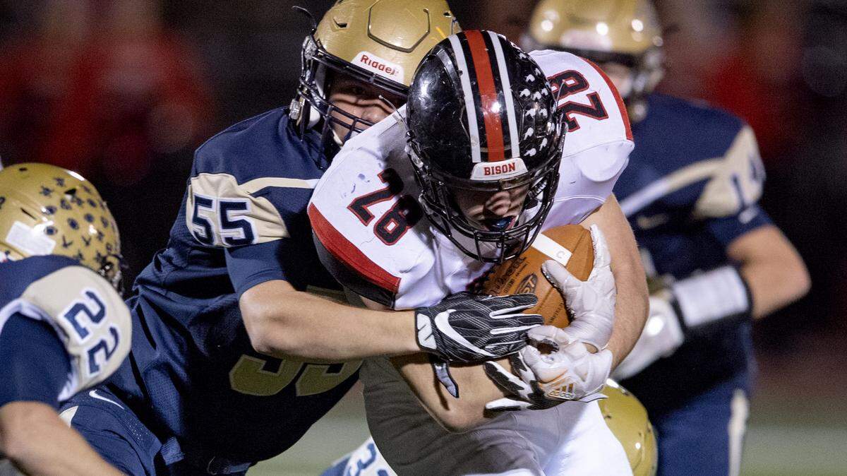 Bald Eagle Area’s Tyler Bumbarger stops Clearfield’s ballcarrier Brett Zattoni during the game on Friday, Oct. 12, 2018. Clearfield won, 42-7.