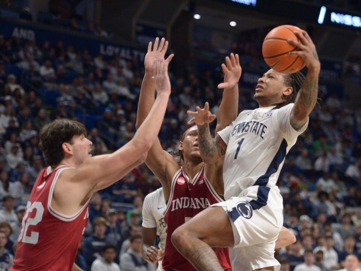 Penn State’s Ace Baldwin Jr. (1) shoots over Indiana’s Trey Galloway, left, and Malik Reneau, center, during the first half of an NCAA college basketball game Saturday Feb. 24, 2024, in State College, Pa.