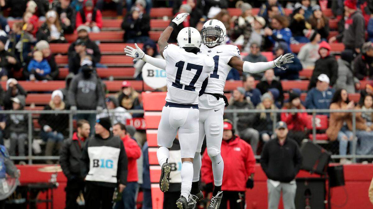 Penn State safety Garrett Taylor (17) celebrates his interception off a pass from Rutgers quarterback Artur Sitkowski, not pictured, with teammate cornerback Amani Oruwariye (21) during the first half of an NCAA college football game, Saturday, Nov. 17, 2018, in Piscataway, N.J. (AP Photo/Julio Cortez)