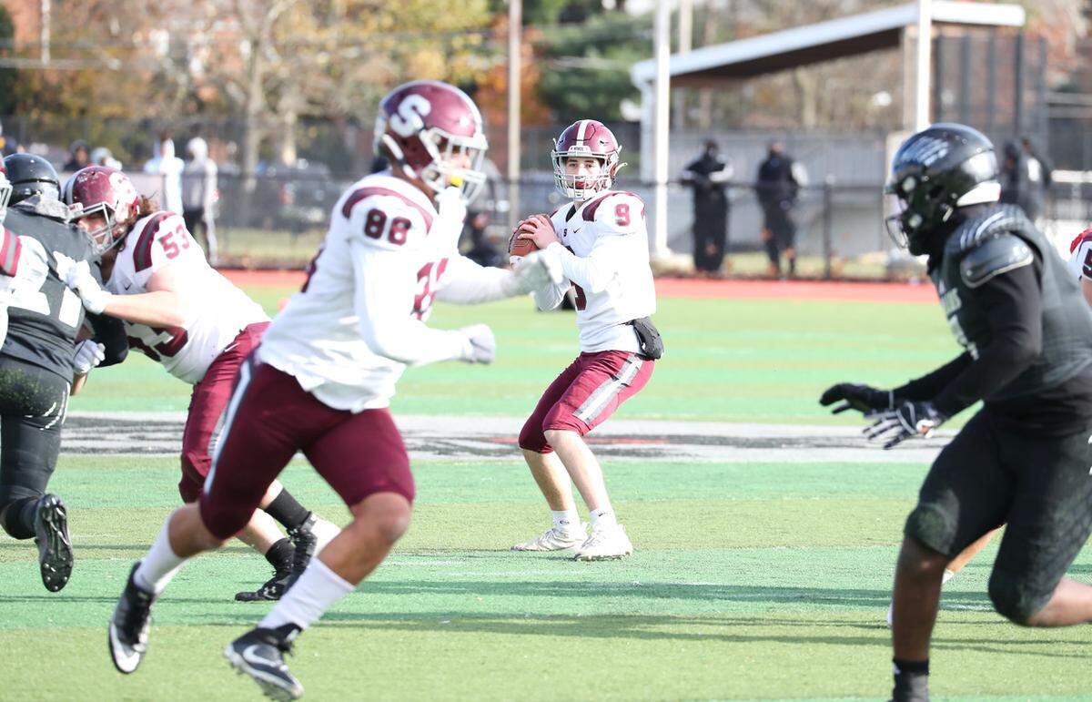State College quarterback Owen Yerka (9) looks to pass while Stephen Scourtis (88) tries to get open against Harrisburg on Saturday, Nov. 27, 2021, at Severance Field in the PIAA quarterfinals. State College won, 16-13.