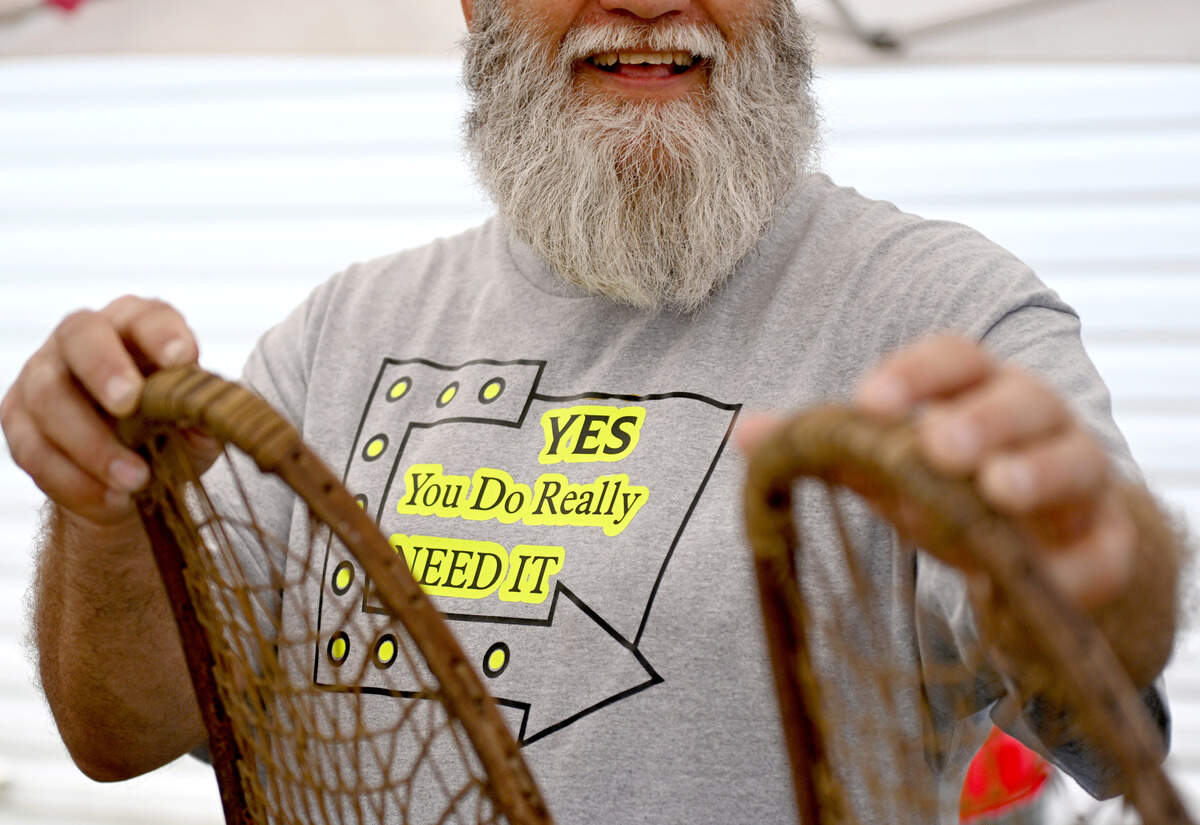 Cliff Cagle wears a homemade shirt, “YES you Do really Need IT,” as he talks about items at his yard sale in Snow Shoe during the 100 Mile Yard Sale on Friday, July 17, 2026.