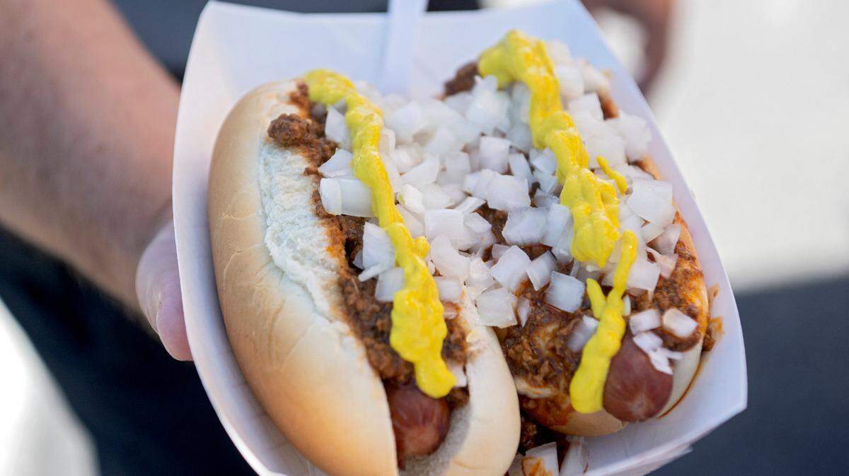 Two Mexi Hot dogs, which features meat sauce, chopped onions and mustard, from Dog’s on the Run.