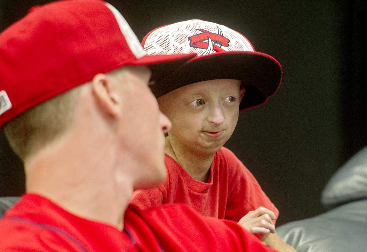 Josiah Viera jokes with pitcher Brady Bowen as they change the channel from MLB games to Shark Week in the clubhouse lounge before the July 3, 2016 game.