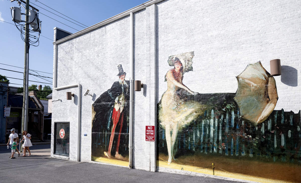 A large-scale replica of the painting “The Vaudeville Act, 1902-03” by Everett Shinn on display at 320 E. Calder Way as part of the “Looking at US: Celebrating America’s 250th” installation.