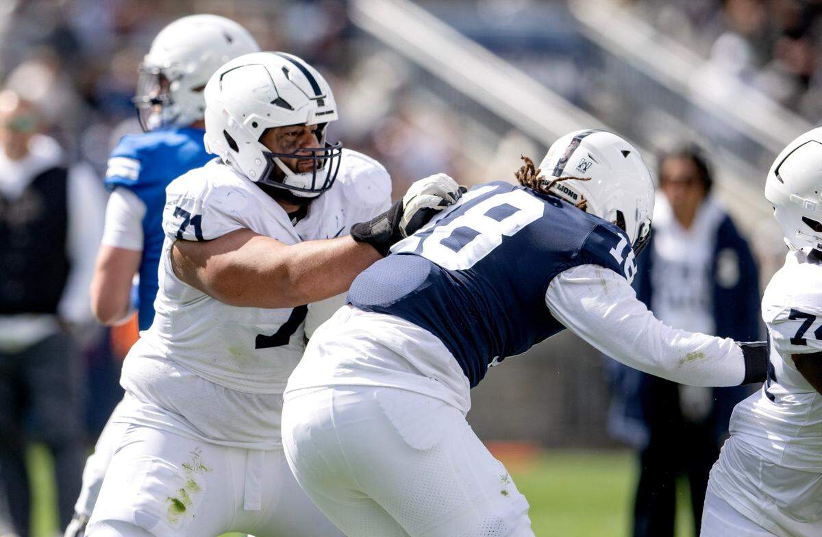 Penn State offensive lineman Vega Ioane blocks defensive end Davon Townley Jr. during the Blue-White game on Saturday, April 13, 2024.