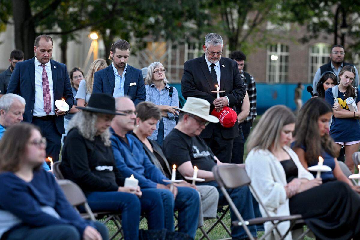 State Sen. Cris Dush bows his head during a moment of silence for Charlie Kirk at a candlelight vigil hosted by the Penn State College Republicans and the Penn State chapter of Turning Point USA on Thursday, Sept. 11, 2025 on the Old Main lawn. 