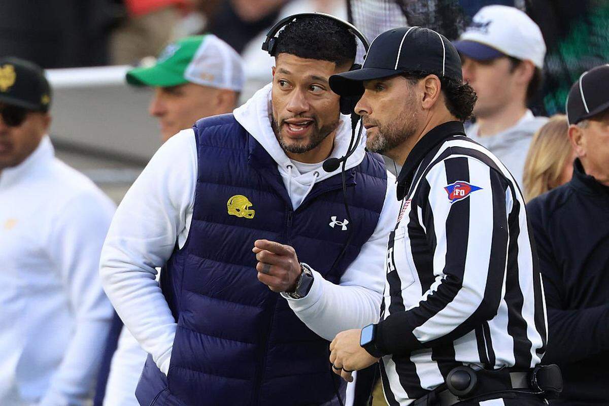 SOUTH BEND, INDIANA - NOVEMBER 22: Head coach Marcus Freeman of the Notre Dame Fighting Irish speaks to an official during the first half against the Syracuse Orange at Notre Dame Stadium on November 22, 2025 in South Bend, Indiana. (Photo by Justin Casterline/Getty Images)