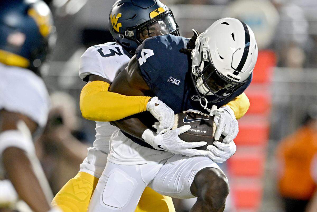 Penn State wide receiver Malick Meiga makes a catch as West Virginia’s Keyshawn Cobb tries to stop him during the game on Saturday, Sept. 2, 2023.
